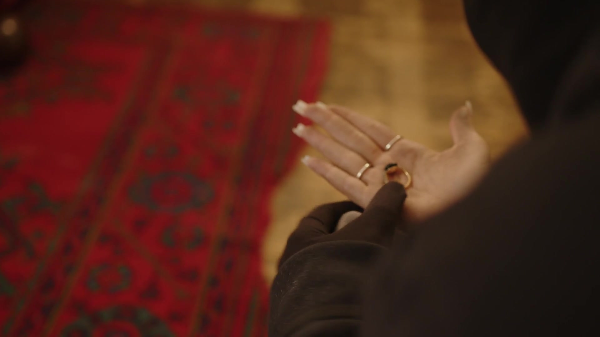 A close-up of a hand holding a small object.