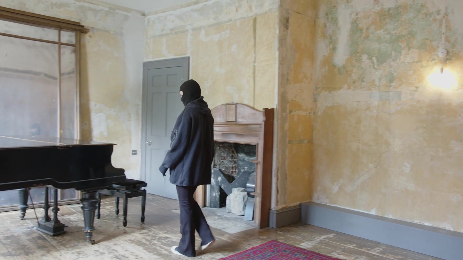 A masked figure beside a piano in Stolen Sonata.