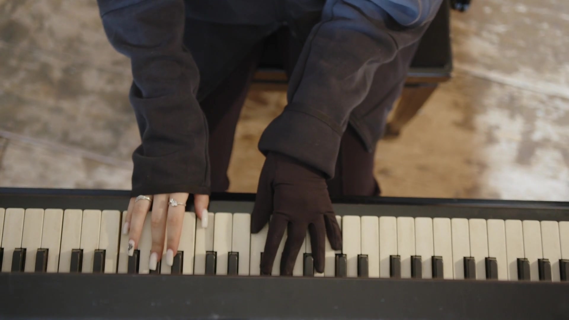 Hands at the piano keyboard.