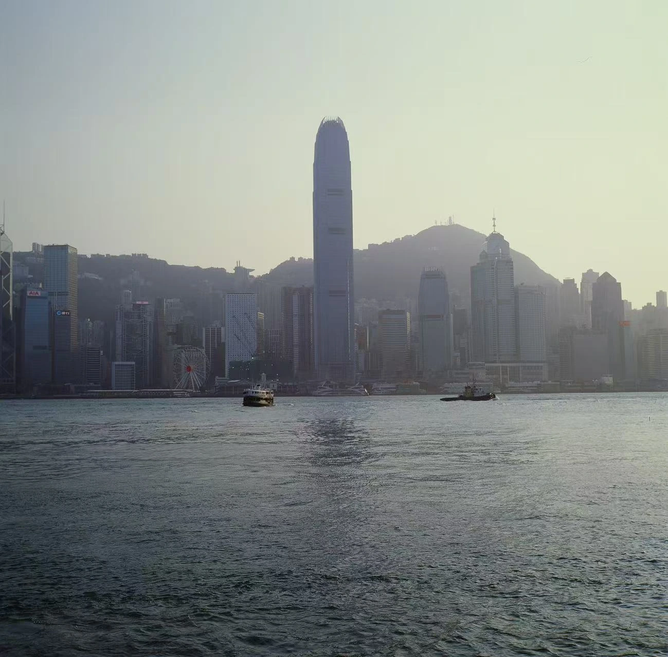 A waterfront skyline seen through haze.